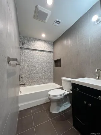 a bathroom with a toilet a sink and bathtub