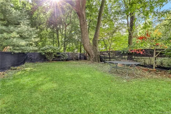 a view of yard with green space and seating area