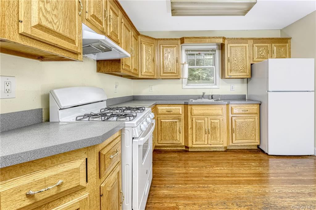 65 South Airmont Road Suffern, NY 10901 - Photo 6 of 23 a kitchen with stainless steel appliances granite countertop a sink a stove and a refrigerator