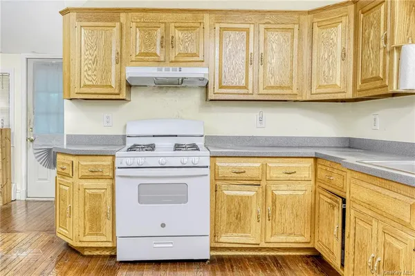a kitchen with stainless steel appliances granite countertop white cabinets and a granite counter tops