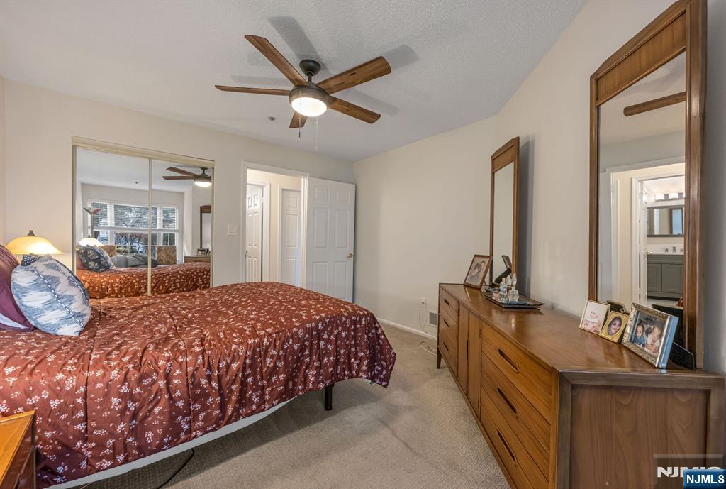 1155 Garrison Court Mahwah, NJ 07430 - Photo 15 of 26 a bedroom with a large bed and a chandelier