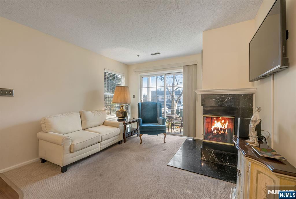 1155 Garrison Court Mahwah, NJ 07430 - Photo 5 of 26 a living room with furniture and a fireplace