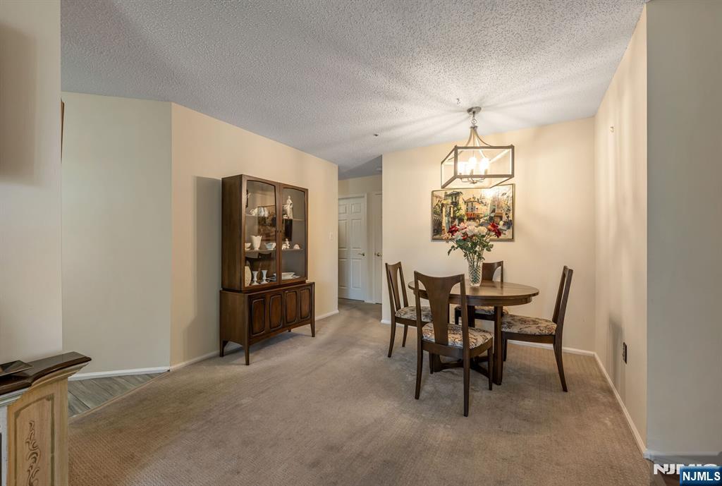1155 Garrison Court Mahwah, NJ 07430 - Photo 7 of 26 a view of a dining room with furniture and chandelier