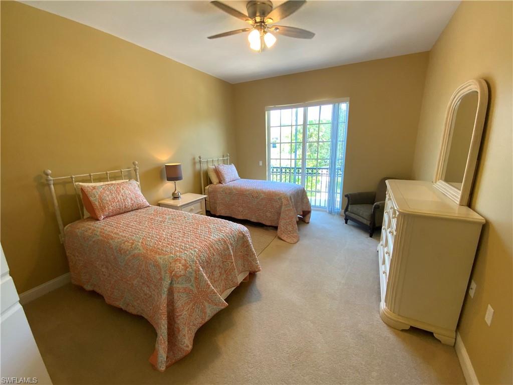 1315 Remington Way, Unit 1201 Naples, FL 34110 - Photo 11 of 20 Bedroom with access to outside, light colored carpet, and ceiling fan