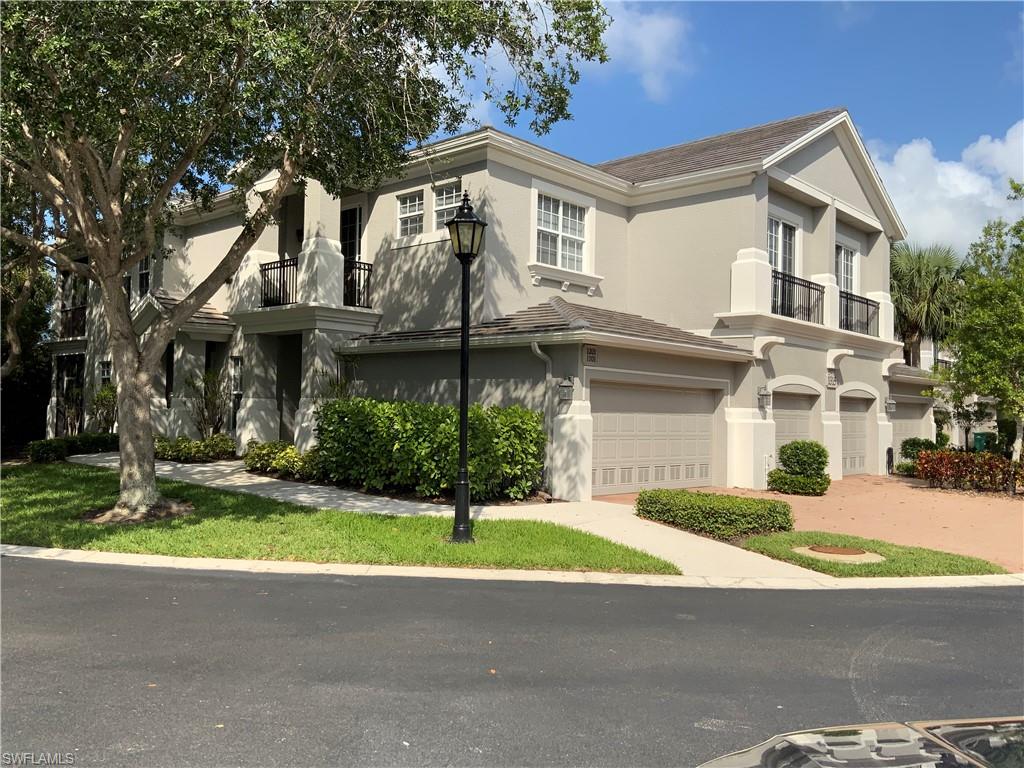 1315 Remington Way, Unit 1201 Naples, FL 34110 - Photo 14 of 20 View of front facade with stucco siding and an attached garage