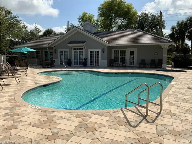 a view of house with swimming pool and furniture