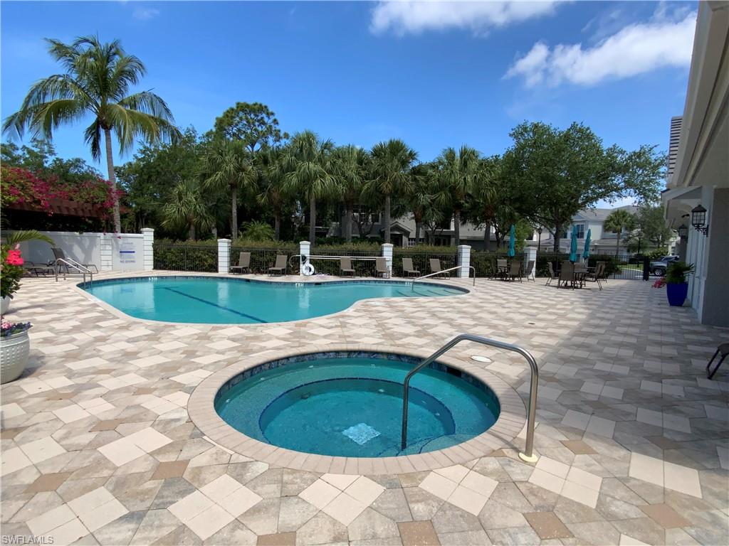 1315 Remington Way, Unit 1201 Naples, FL 34110 - Photo 17 of 20 Community pool with a patio and a hot tub
