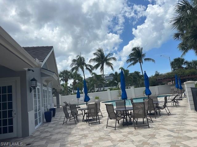 1315 Remington Way, Unit 1201 Naples, FL 34110 - Photo 19 of 20 View of patio with outdoor dining space