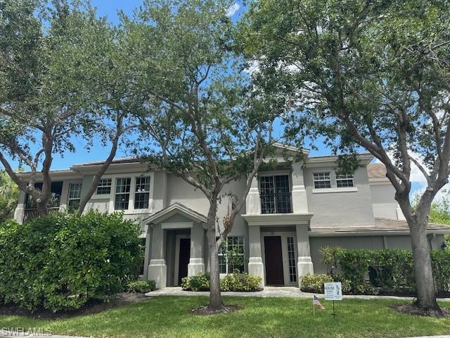 1315 Remington Way, Unit 1201 Naples, FL 34110 - Photo 20 of 20 Traditional-style home featuring stucco siding and a front lawn