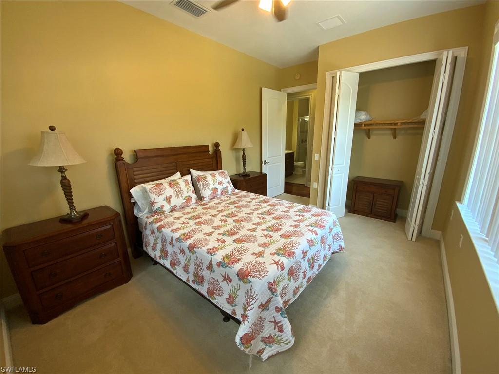 1315 Remington Way, Unit 1201 Naples, FL 34110 - Photo 10 of 20 Bedroom featuring a closet, light colored carpet, and a ceiling fan