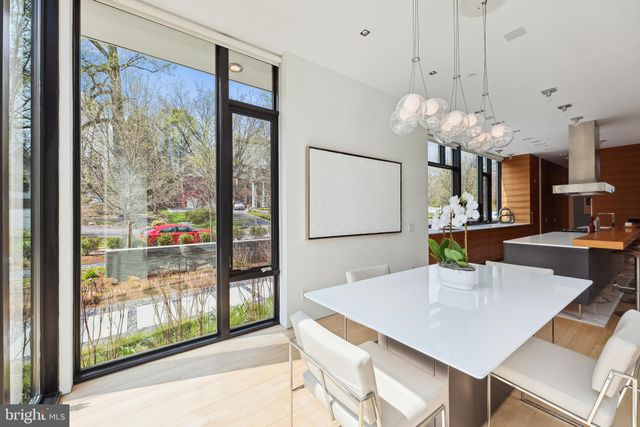 a view of a dining room with furniture a chandelier and wooden floor