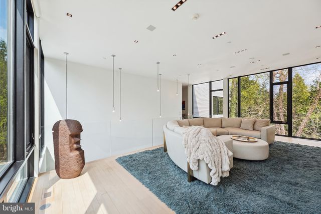a living room with furniture and large windows