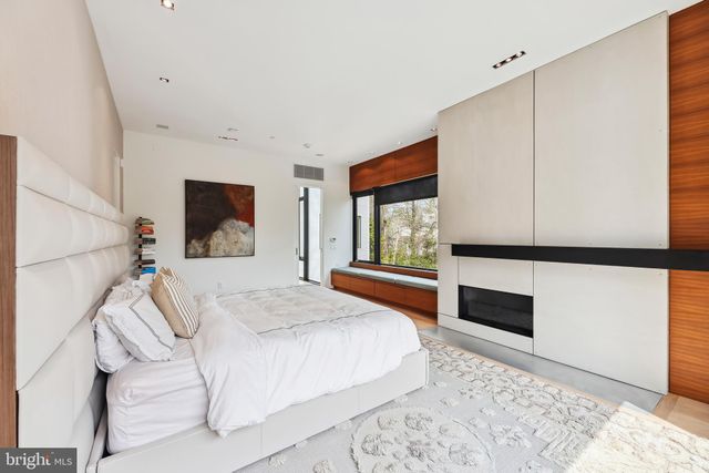 a spacious bathroom with a granite countertop sink and a mirror