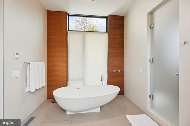a view of a walk in closet with clothes and shoes