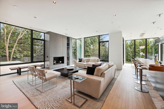 a living room with furniture and large windows