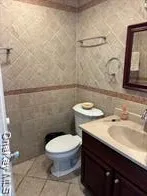 a bathroom with a sink a toilet and a mirror