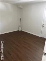 an empty room with wooden floor