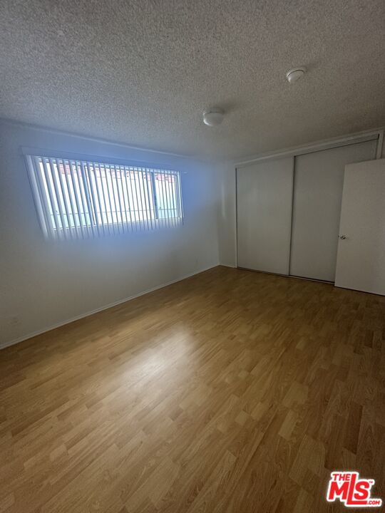 11525 Rochester Avenue, Unit 201 Los Angeles, CA 90025 - Photo 12 of 12 a view of an empty room with wooden floor
