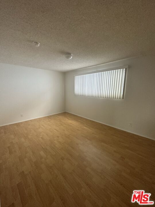 11525 Rochester Avenue, Unit 201 Los Angeles, CA 90025 - Photo 8 of 12 an empty room with a empty space and windows