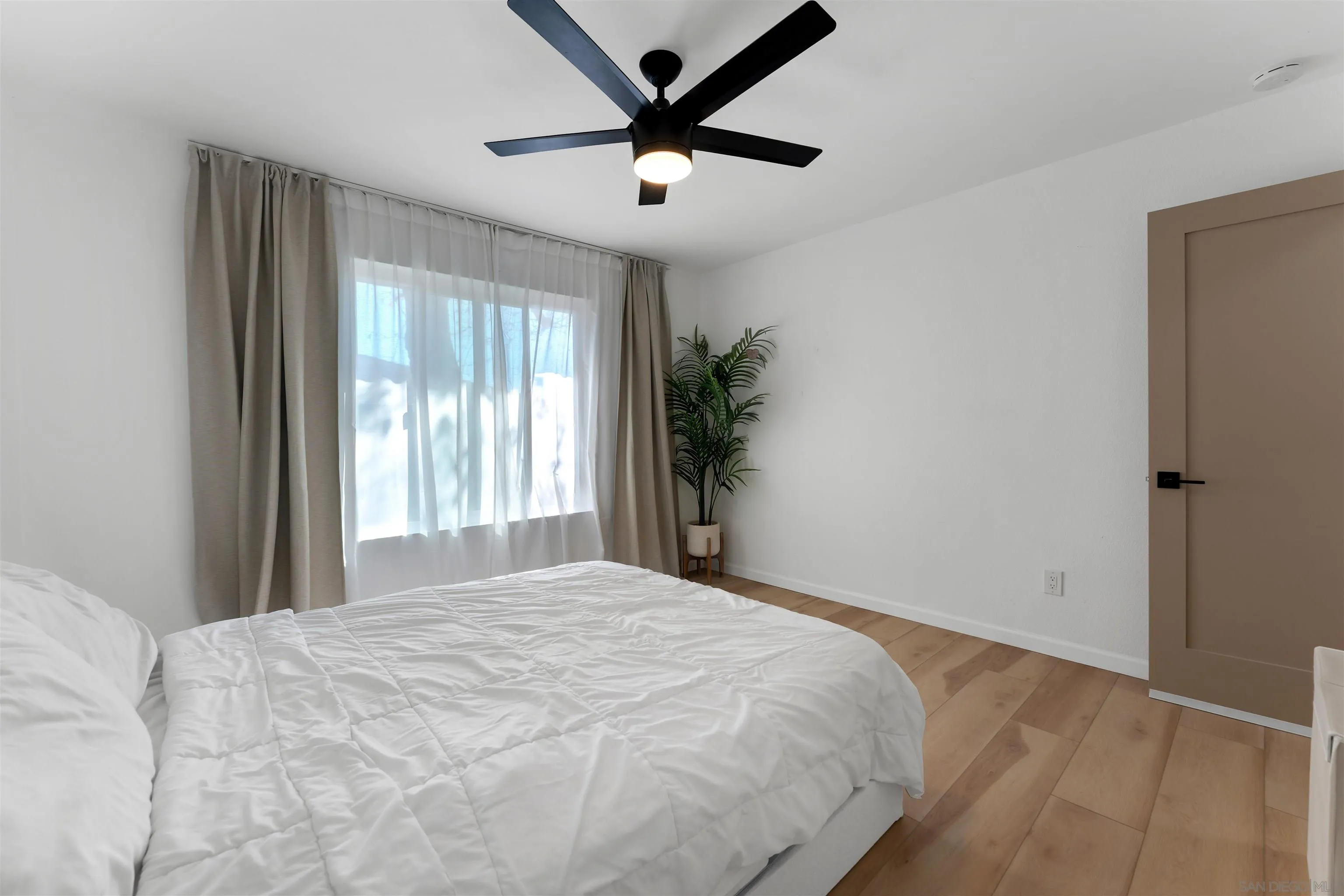 1622 Summertime Drive El Cajon, CA 92021 - Photo 15 of 27 a bedroom with a bed and a large window