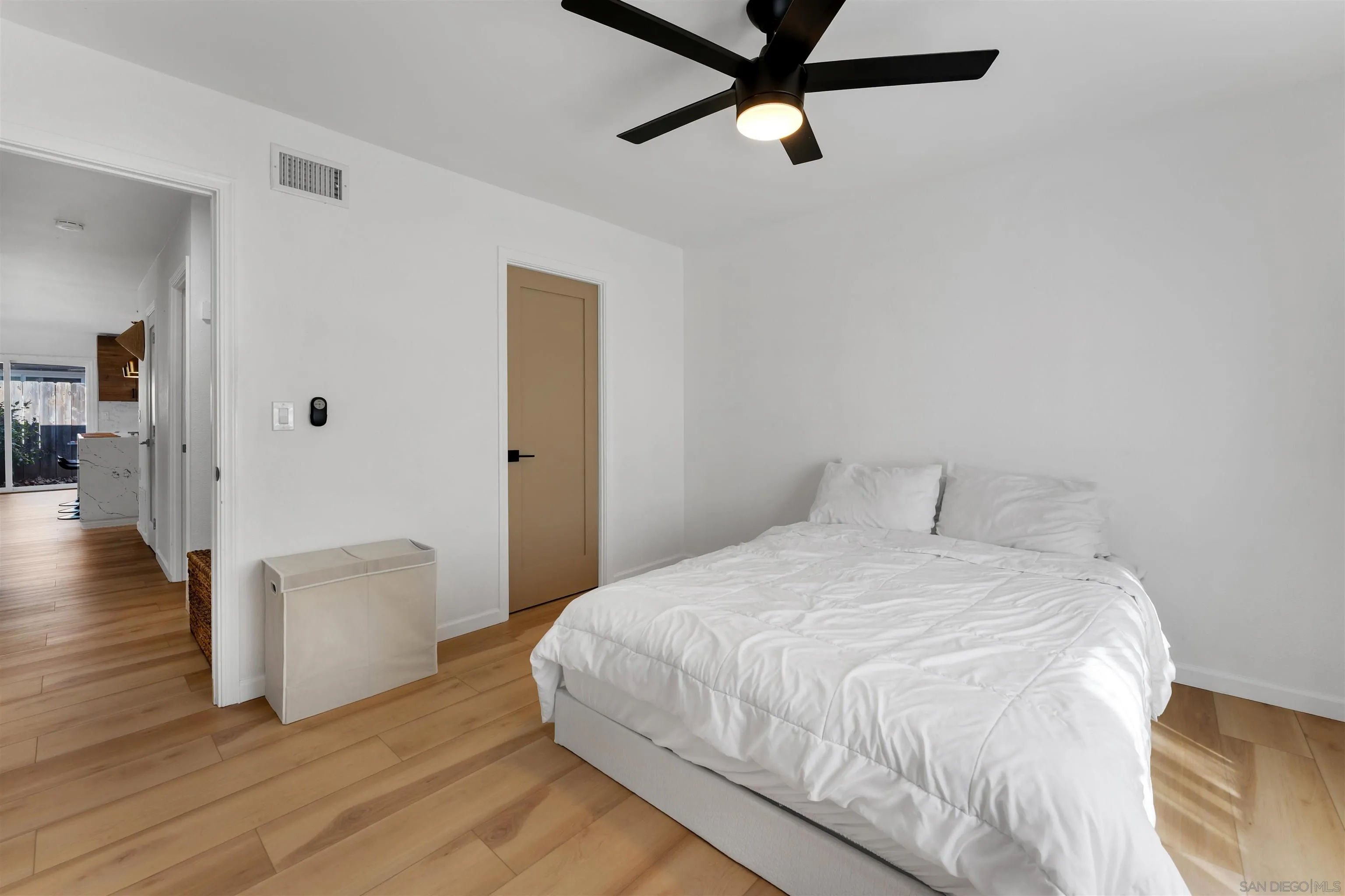 1622 Summertime Drive El Cajon, CA 92021 - Photo 16 of 27 a bedroom with a bed and wooden floor