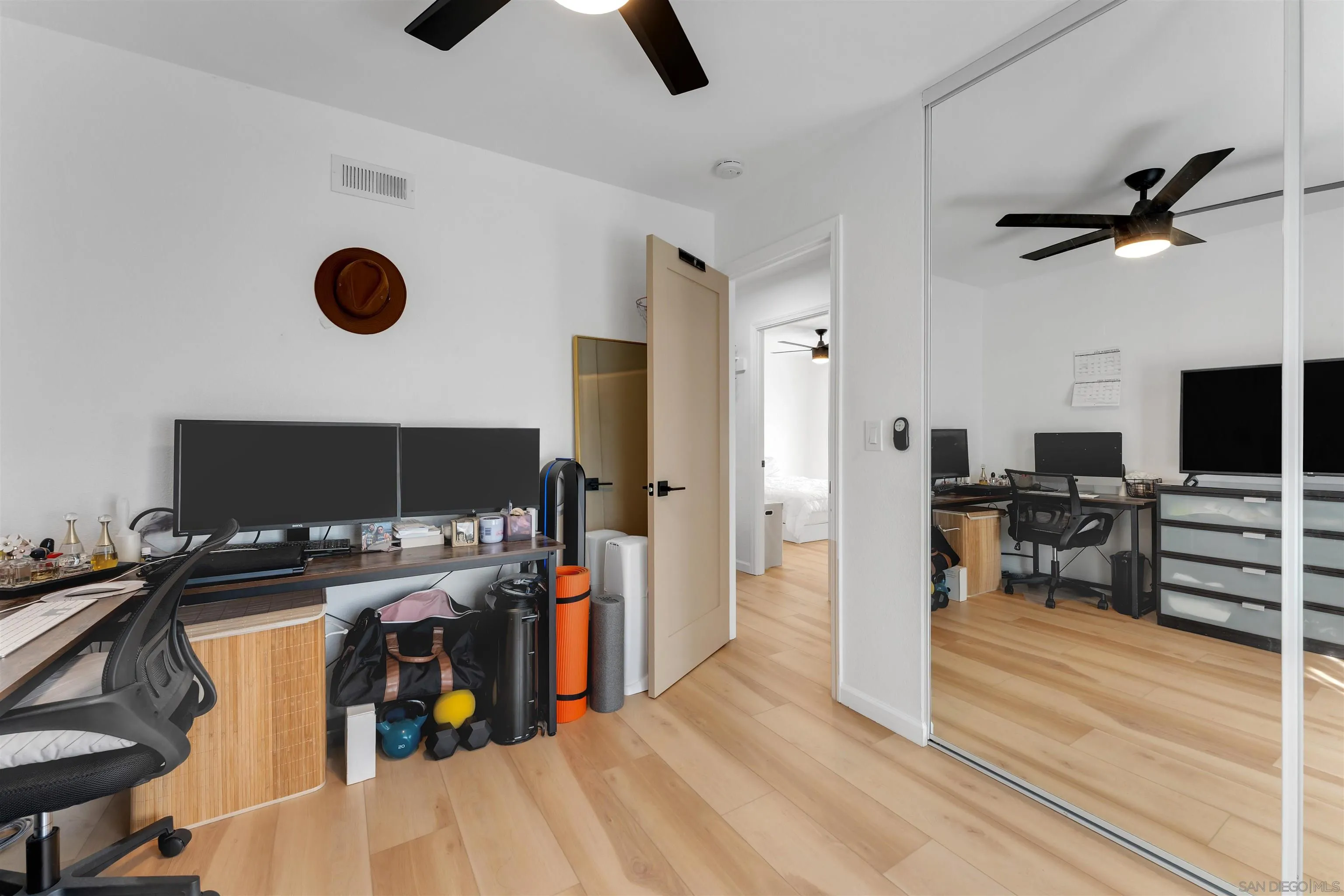 1622 Summertime Drive El Cajon, CA 92021 - Photo 20 of 27 a view of a workspace with furniture and a flat screen tv