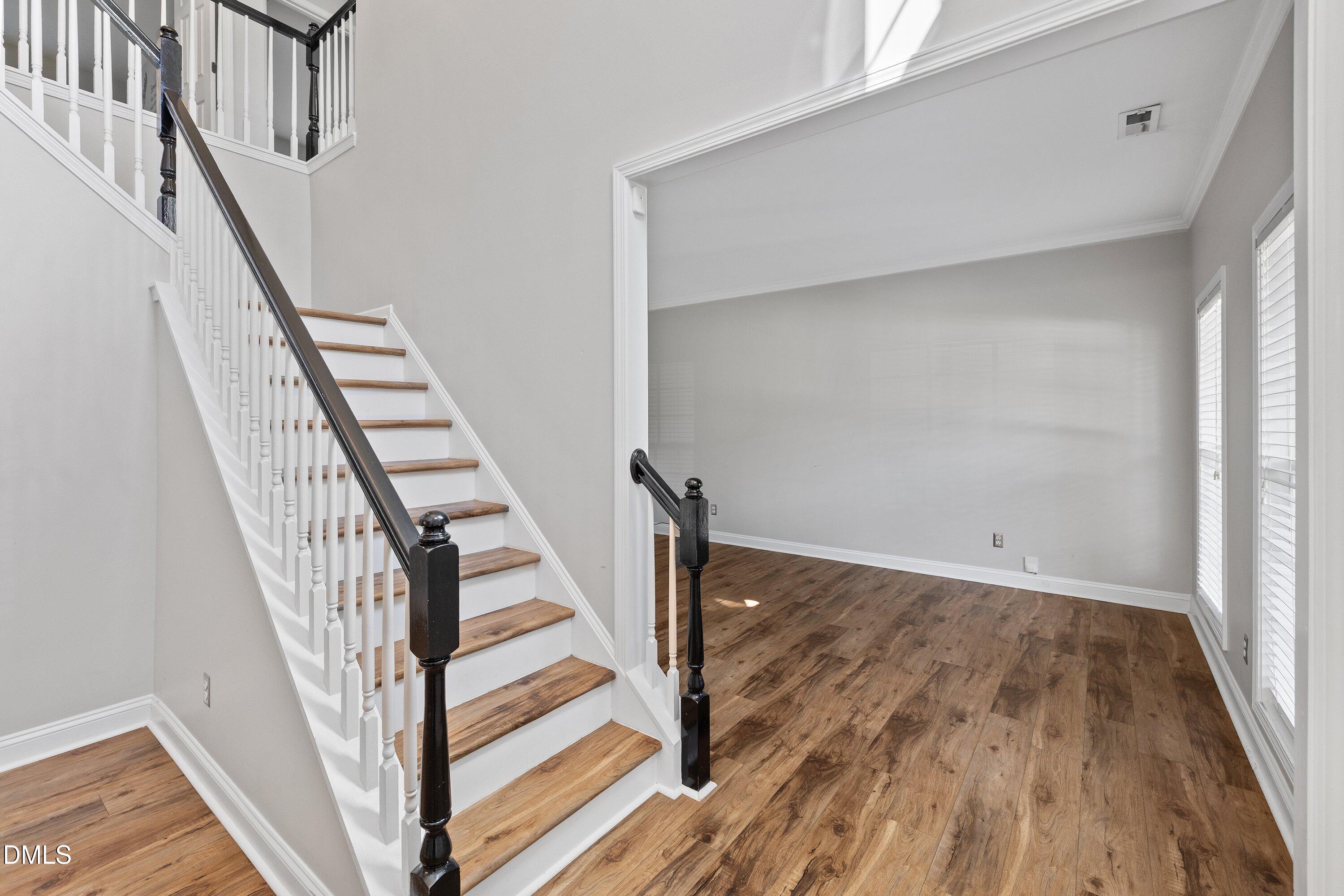 3717 Windmeade Road Wake Forest, NC 27587 - Photo 7 of 51 a view of staircase with wooden floor and white walls