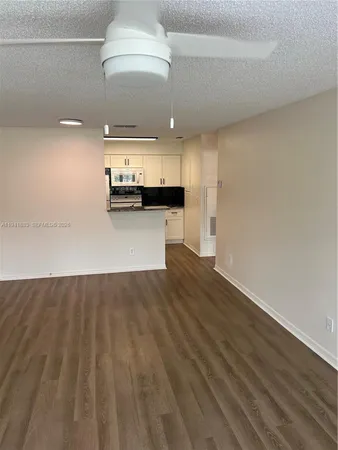 a view of a kitchen with a sink and cabinets