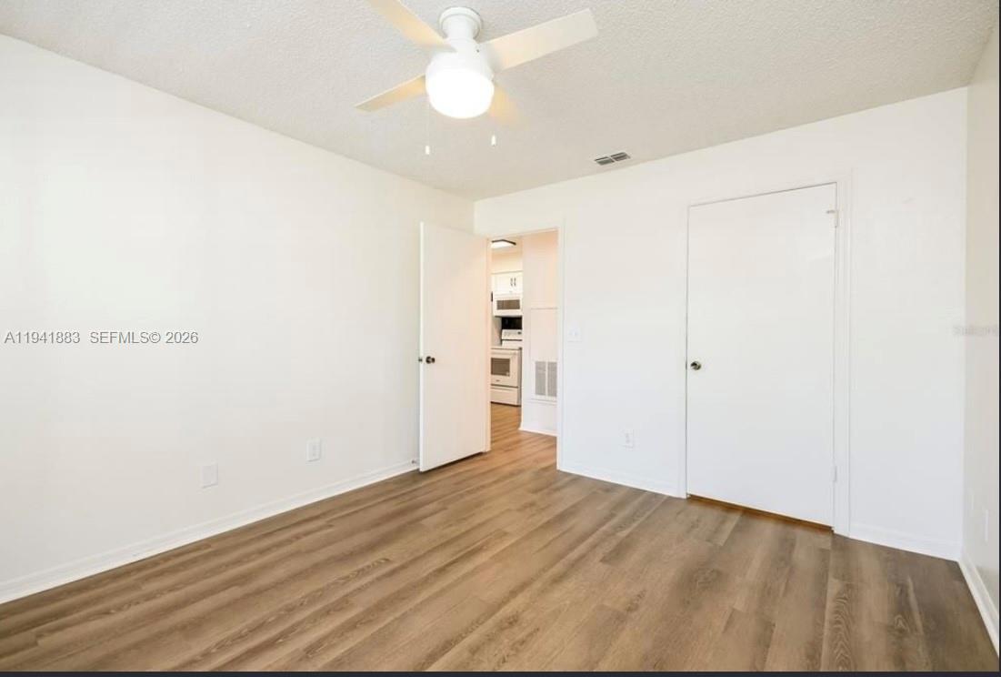 1055 South Hiawassee Road, Unit 2014 Orlando, FL 32835 - Photo 13 of 22 a view of empty room with wooden floor