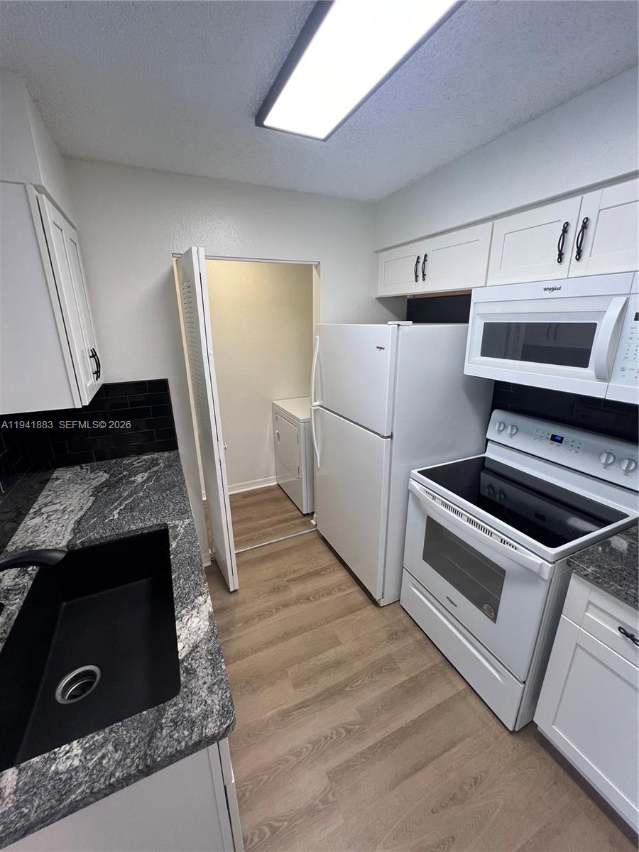 1055 South Hiawassee Road, Unit 2014 Orlando, FL 32835 - Photo 16 of 22 a kitchen with granite countertop a stove and a refrigerator