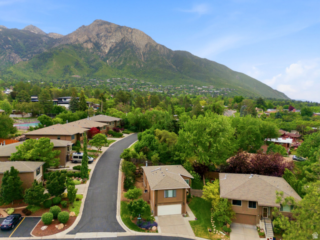 3674 Oak Rim Way Salt Lake City, UT 84109 - Photo 42 of 47 Mountain backdrop with a residential street featuring multiple homes, mature trees, and landscaped shrubbery