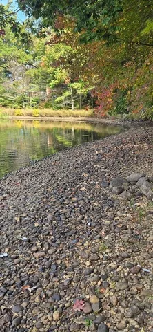 a kitchen with granite countertop a refrigerator and a sink