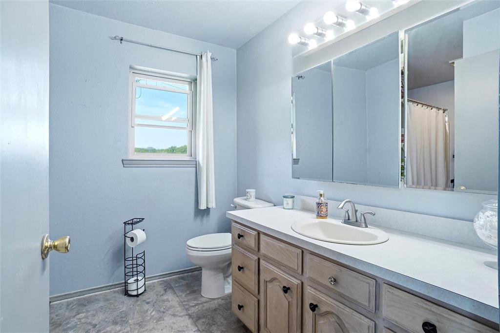8983 Odneal Road West Krum, TX 76249 - Photo 11 of 29 Primary bathroom in house #1 with standup shower.