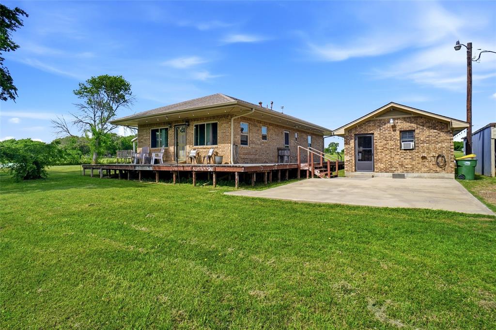 8983 Odneal Road West Krum, TX 76249 - Photo 2 of 29 Main house #1 and Mother-in-law house on the right hand side of the picture. Mother-in-law suite needs to be finished out. It is plumbed for a full bathroom and does not have central heating or air.