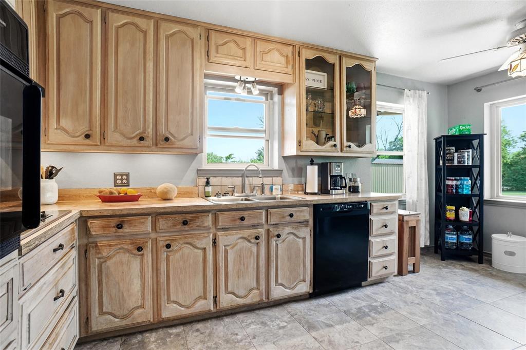 8983 Odneal Road West Krum, TX 76249 - Photo 5 of 29 Show through glass doors on a couple of upper kitchen cabinets. Electric stove.