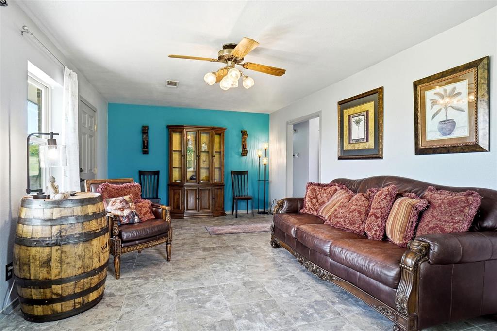 8983 Odneal Road West Krum, TX 76249 - Photo 8 of 29 Living room in house #1 with tile like laminate floors.
