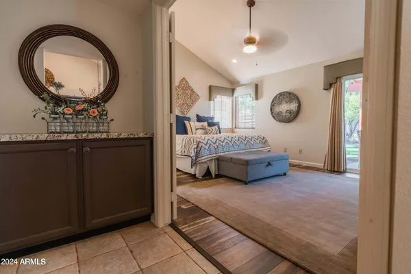 a bedroom with a bed and a chandelier