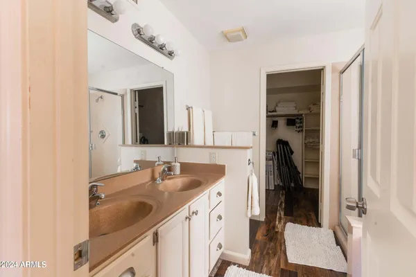 a kitchen with stainless steel appliances granite countertop a table chairs and a refrigerator