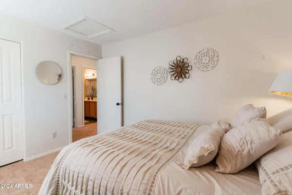 a bedroom with two beds and two mirror