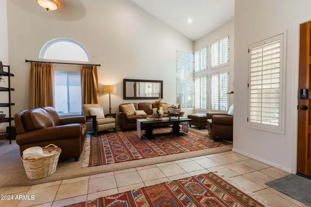 a living room with furniture fireplace and windows