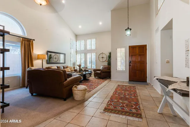 a living room with furniture fireplace and a chandelier