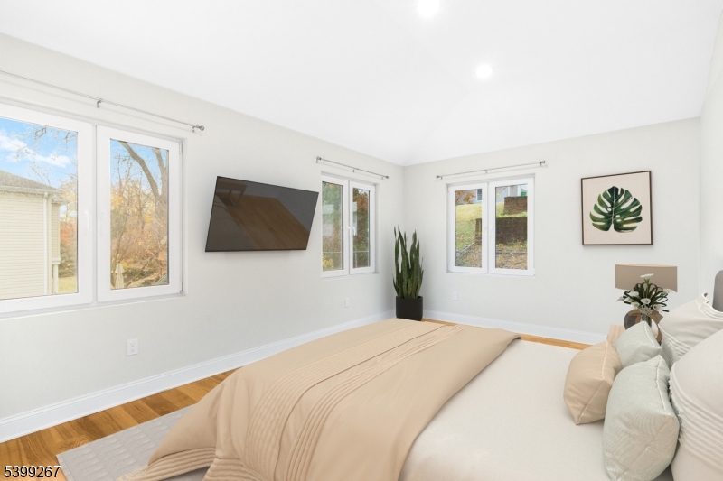 71 St Marys Place, Unit 2 Nutley, NJ 07110 - Photo 13 of 45 a bedroom with a large bed and a flat screen tv