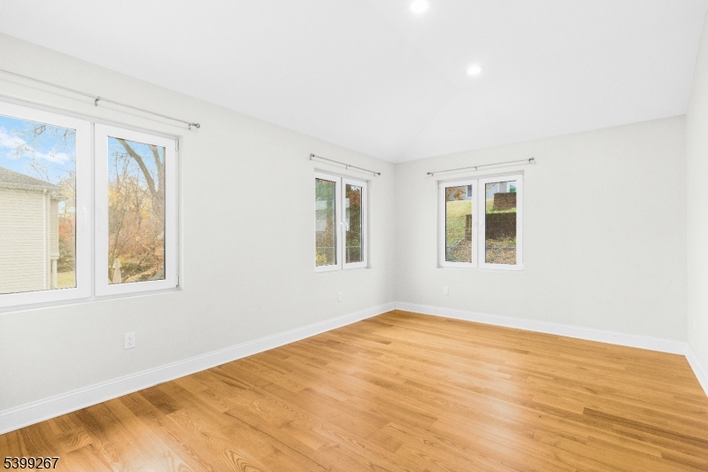 71 St Marys Place, Unit 2 Nutley, NJ 07110 - Photo 14 of 45 a view of an empty room with wooden floor and a window