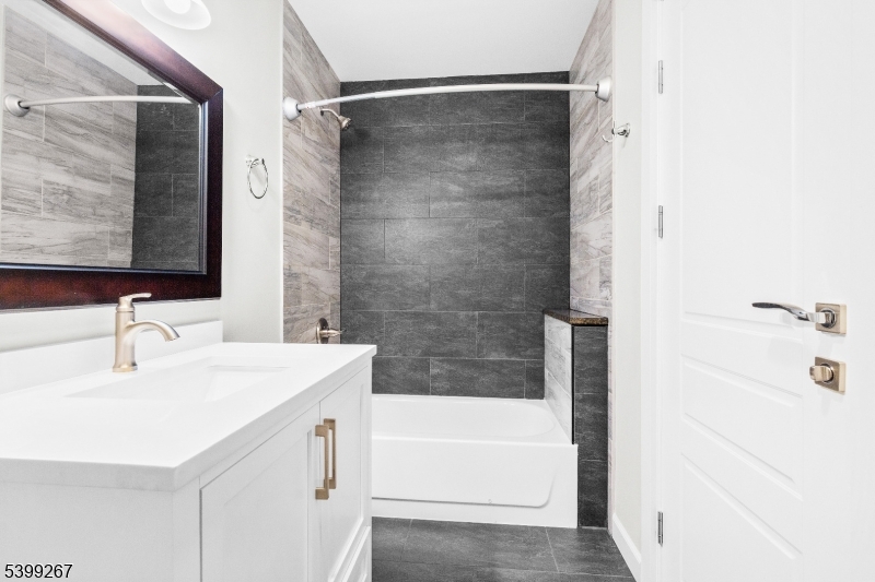 71 St Marys Place, Unit 2 Nutley, NJ 07110 - Photo 15 of 45 a bathroom with a sink a mirror and a bathtub