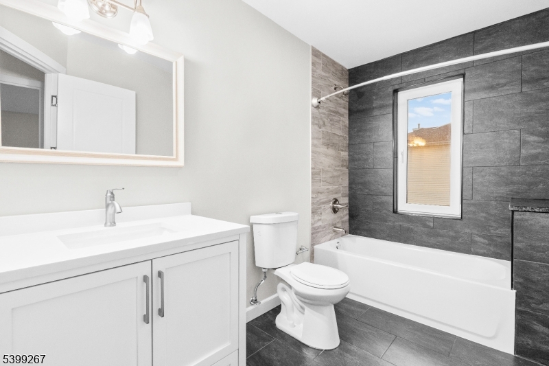 71 St Marys Place, Unit 2 Nutley, NJ 07110 - Photo 24 of 45 a bathroom with a sink toilet vanity and bathtub