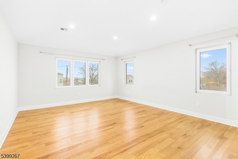 71 St Marys Place, Unit 2 Nutley, NJ 07110 - Photo 32 of 45 a view of an empty room with wooden floor and a window