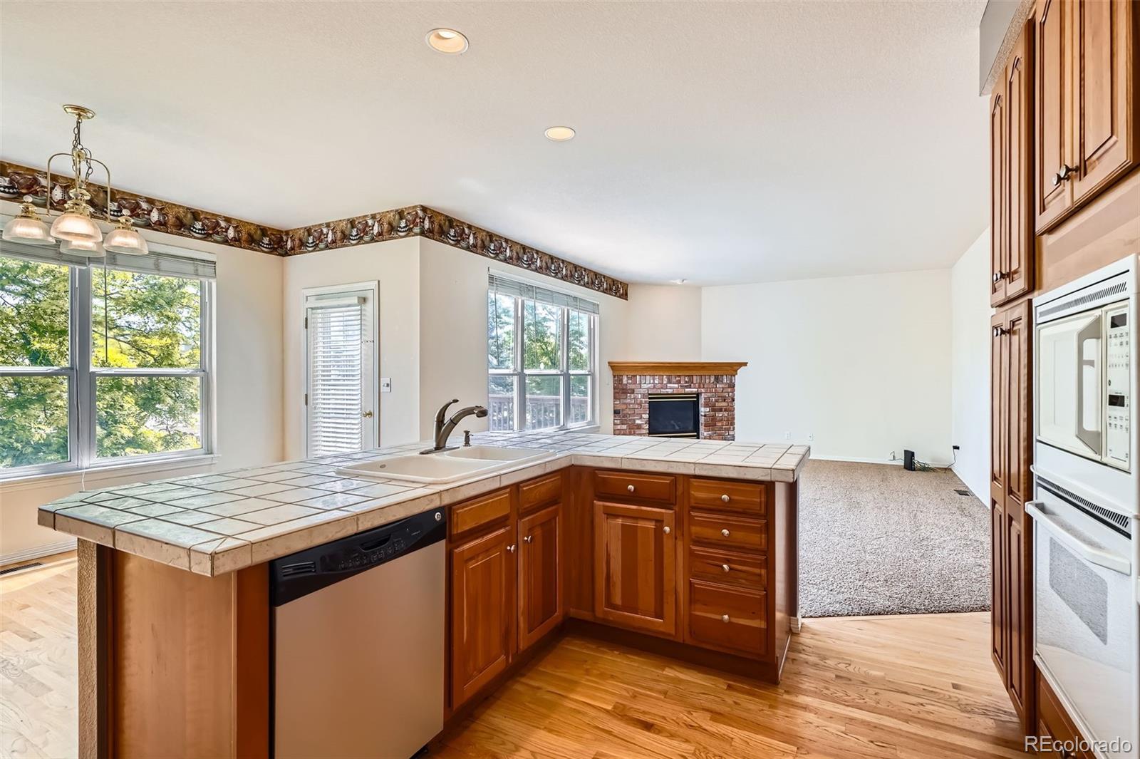 2561 Cactus Bluff Place Highlands Ranch, CO 80129 - Photo 11 of 33 a kitchen that has a sink and a stove in it
