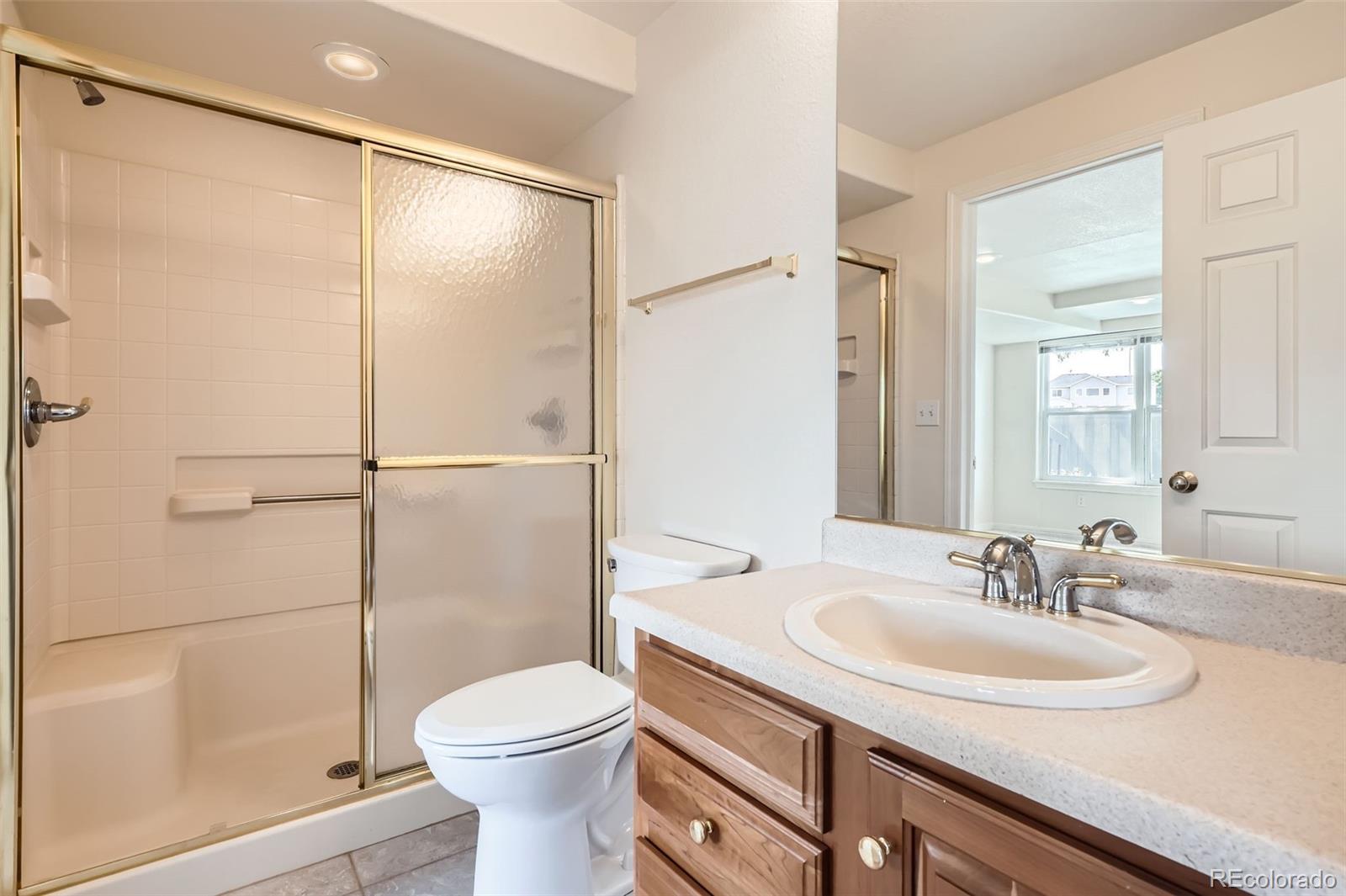 2561 Cactus Bluff Place Highlands Ranch, CO 80129 - Photo 28 of 33 a bathroom with a sink toilet and shower