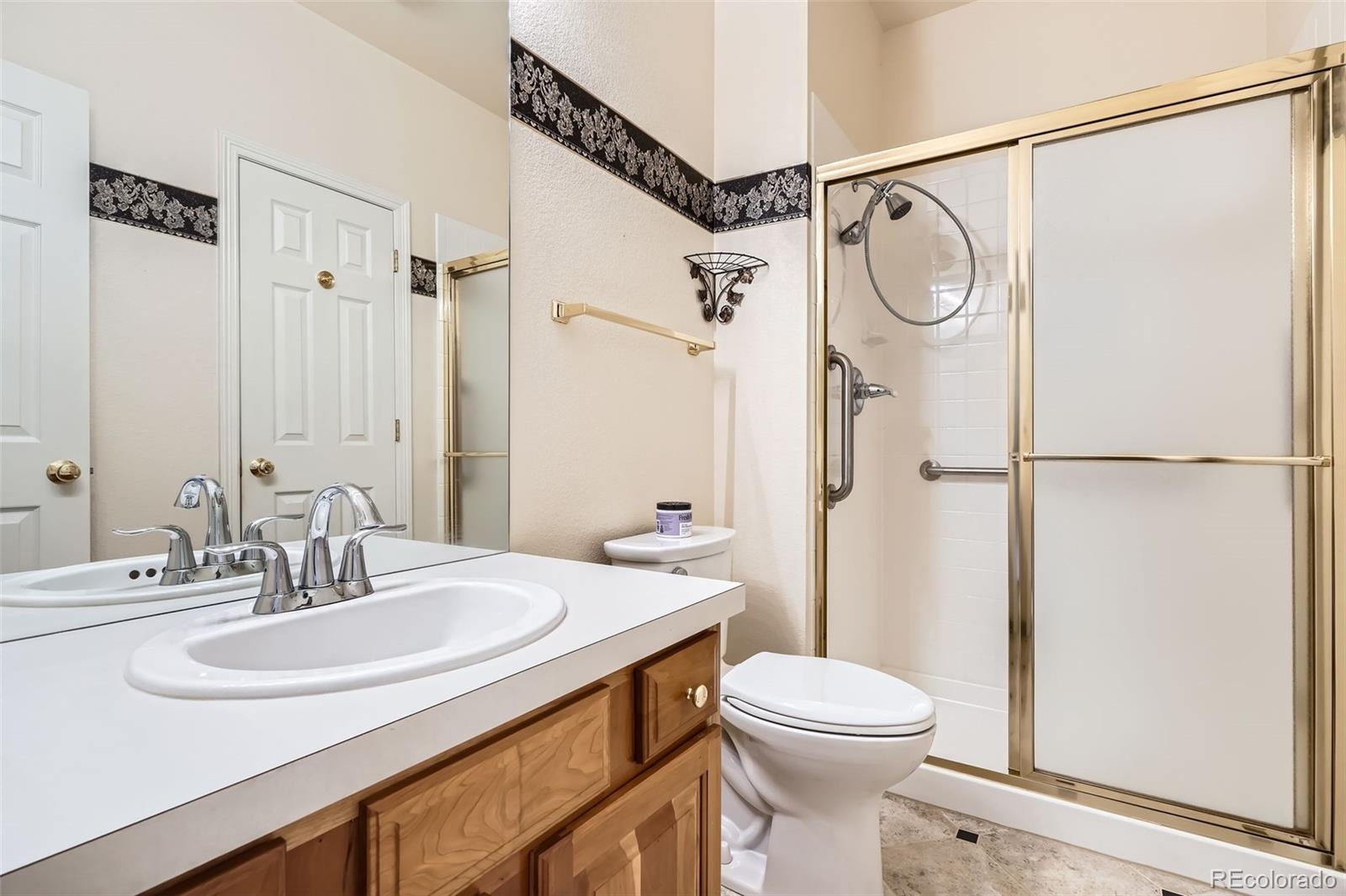2561 Cactus Bluff Place Highlands Ranch, CO 80129 - Photo 31 of 33 a bathroom with a sink toilet and shower