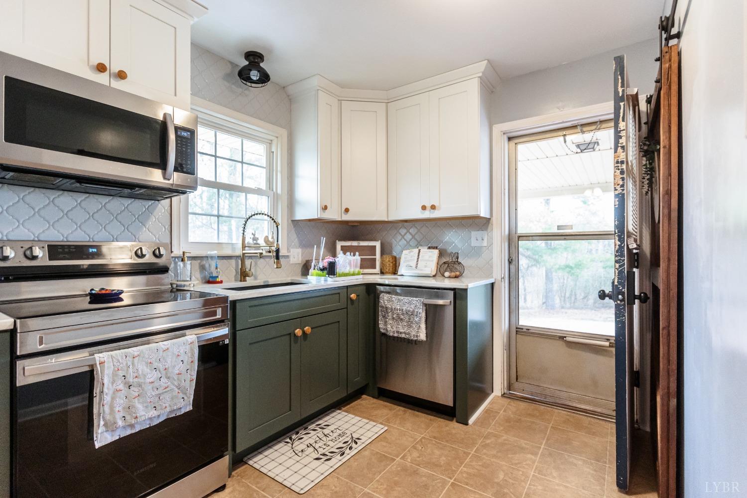 10769 Oakville Road Gladstone, VA 24553 - Photo 11 of 35 a kitchen with stainless steel appliances granite countertop a stove a sink and a microwave